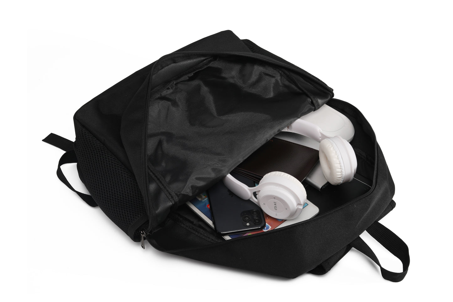 Black backpack with items like a phone and headphones inside on a white background