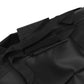 Close-up of a black bag with straps and zippers on a white background