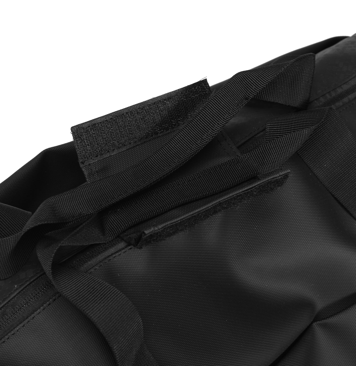 Close-up of a black bag with straps and zippers on a white background