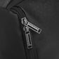 Close-up of a black backpack zipper with brand name on a dark background