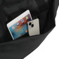 Black backpack with a tablet and phone inside on a white background