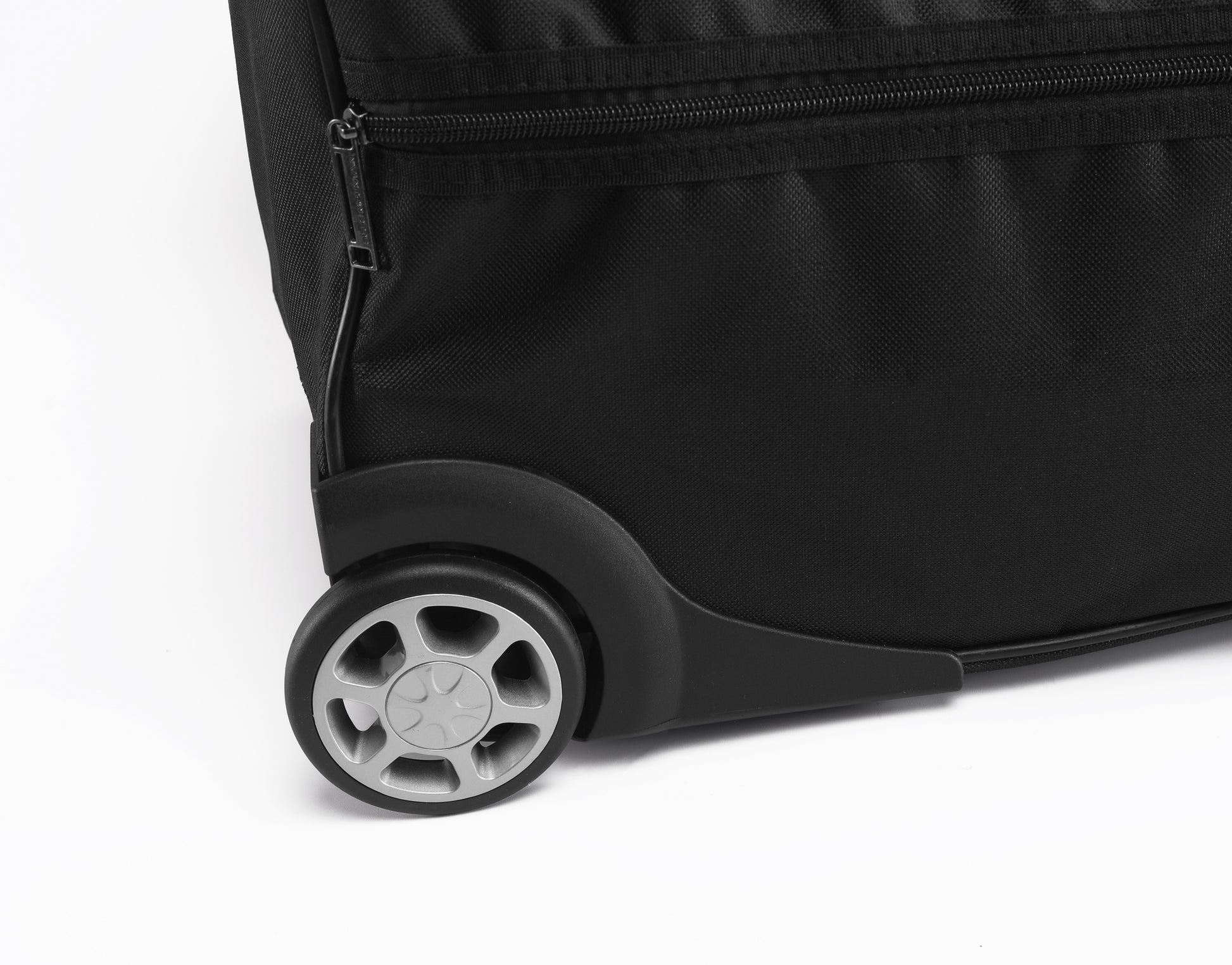 Close-up of a black suitcase wheel on a white background